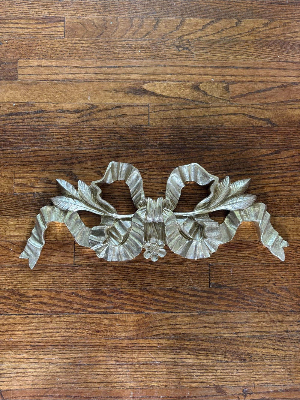 Gold painted wooden bow wall hanging